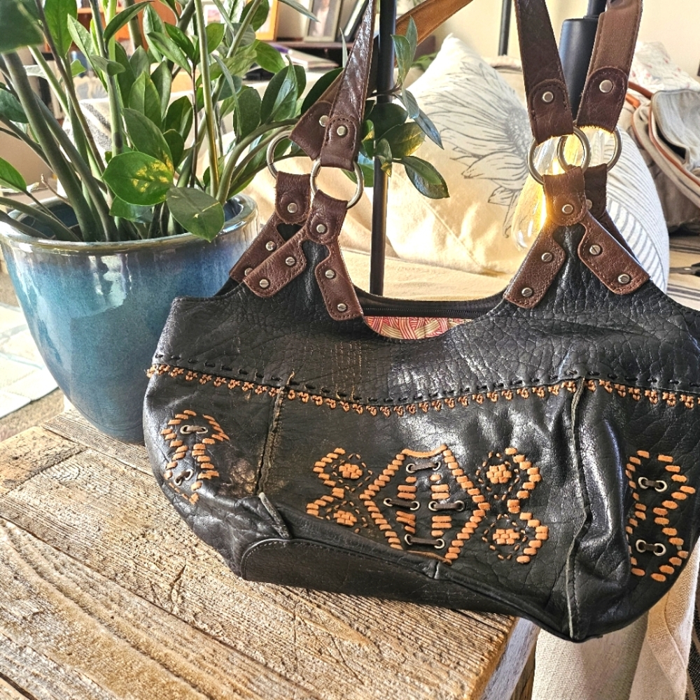 The Sak black and brown leather with weaving.
